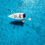A Resting Sailing Boat on Crystal Clear Water